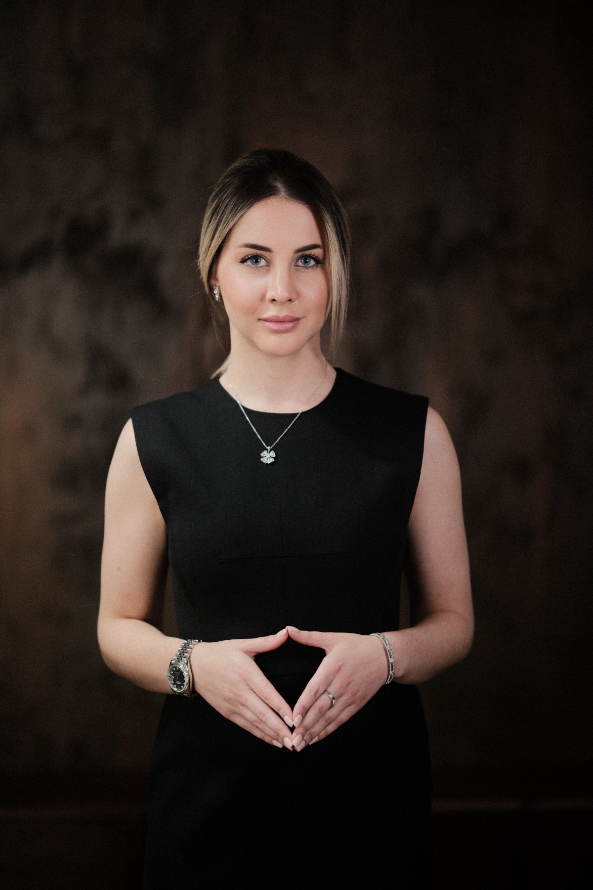 Anna Albu, photographed in three-quarter framing against a dark studio ground.